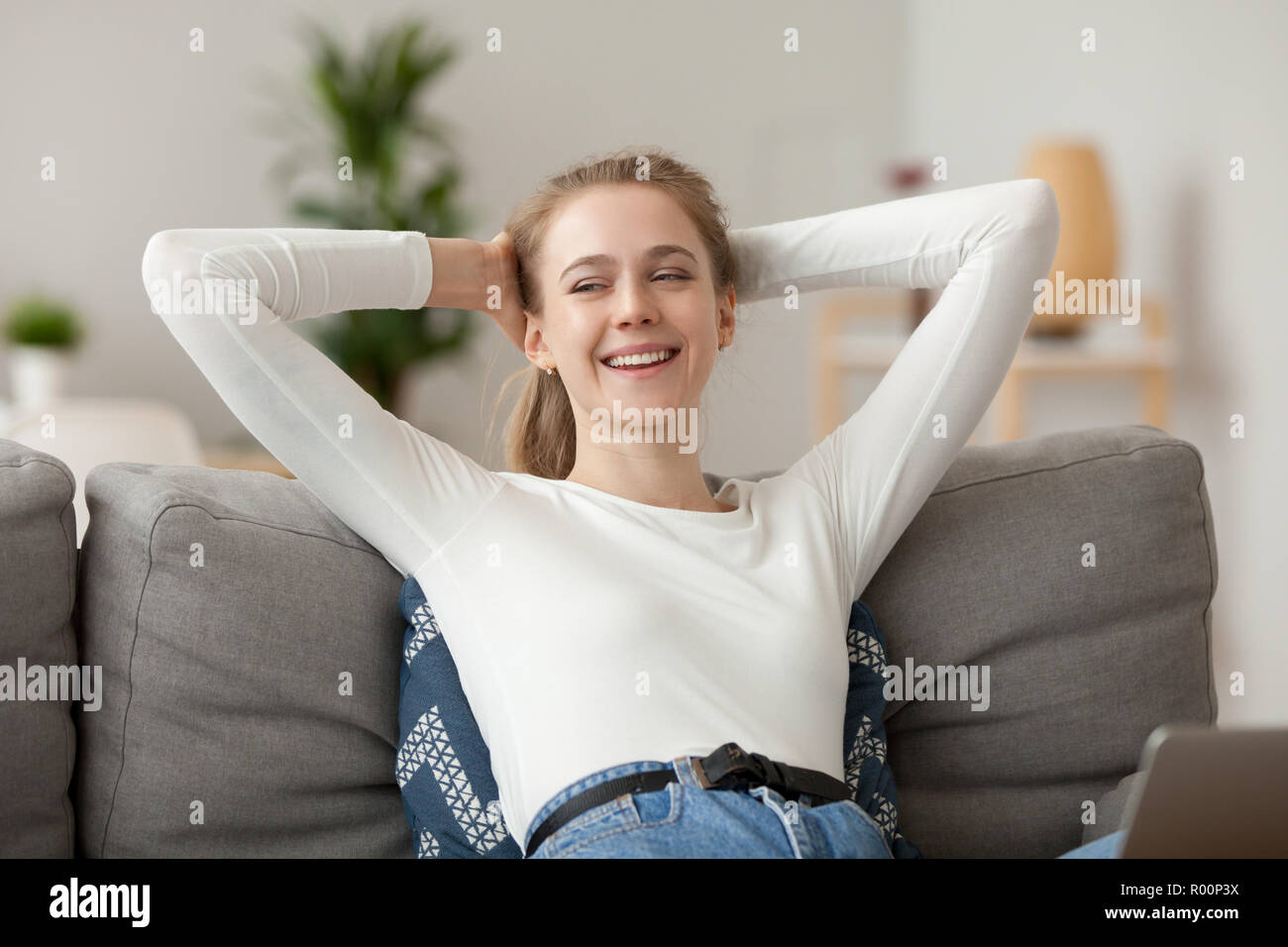 Pretty positive millennial woman relaxing at home Stock Photo