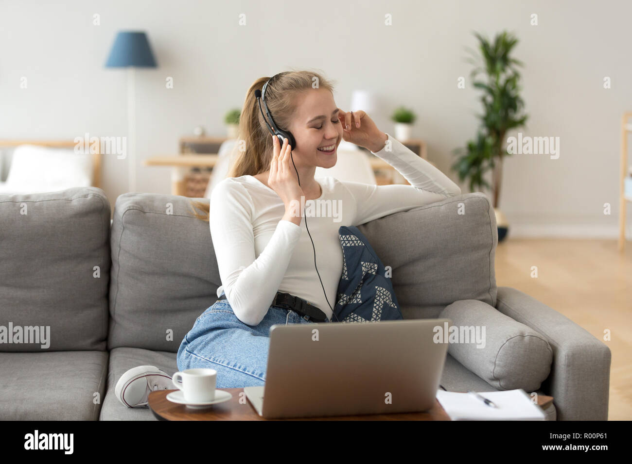 Woman in headset listening music feels good Stock Photo