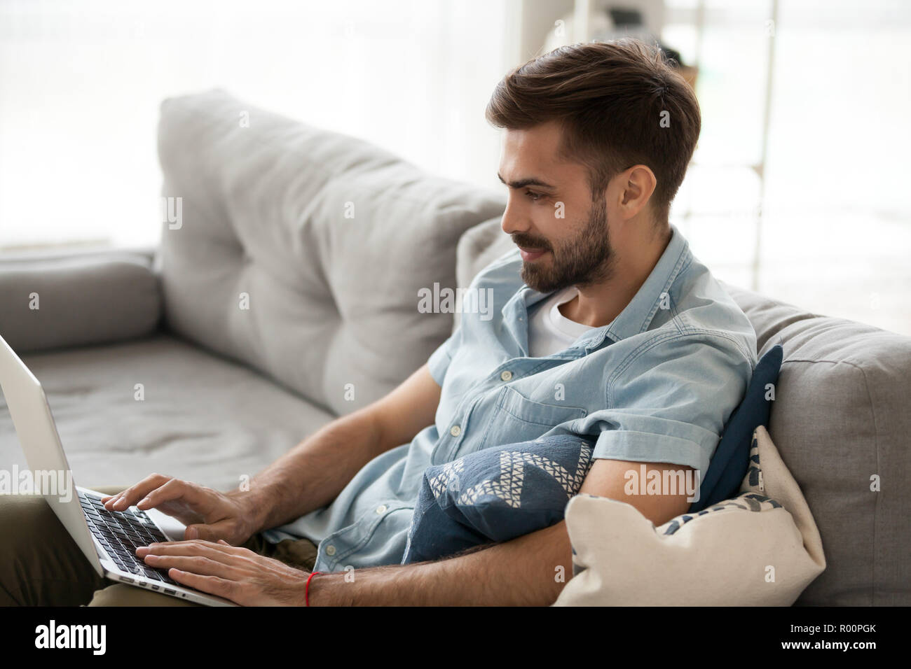 Young man working using laptop at home Stock Photo