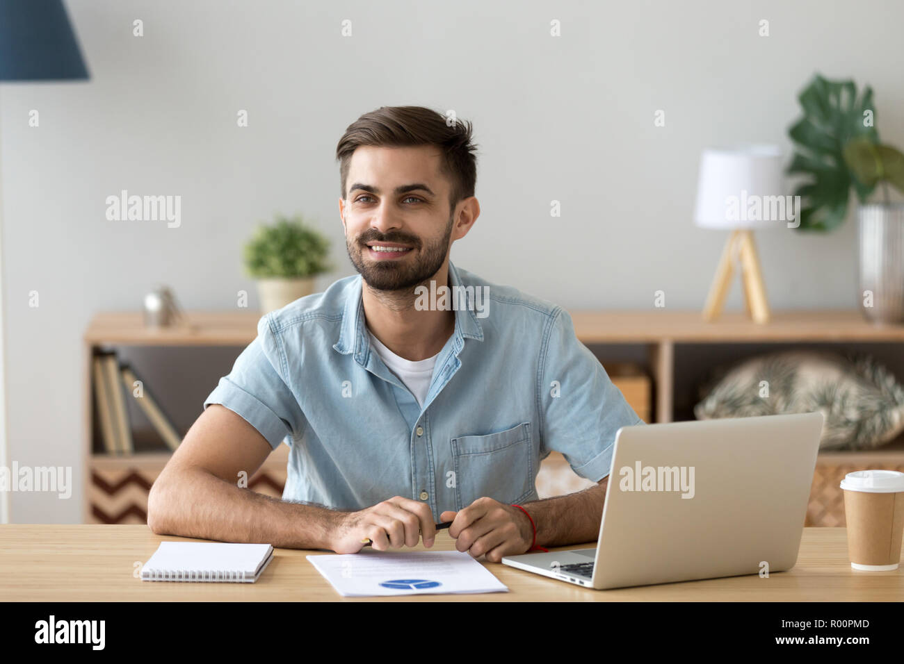 Businessman sitting at the desk in office Stock Photo