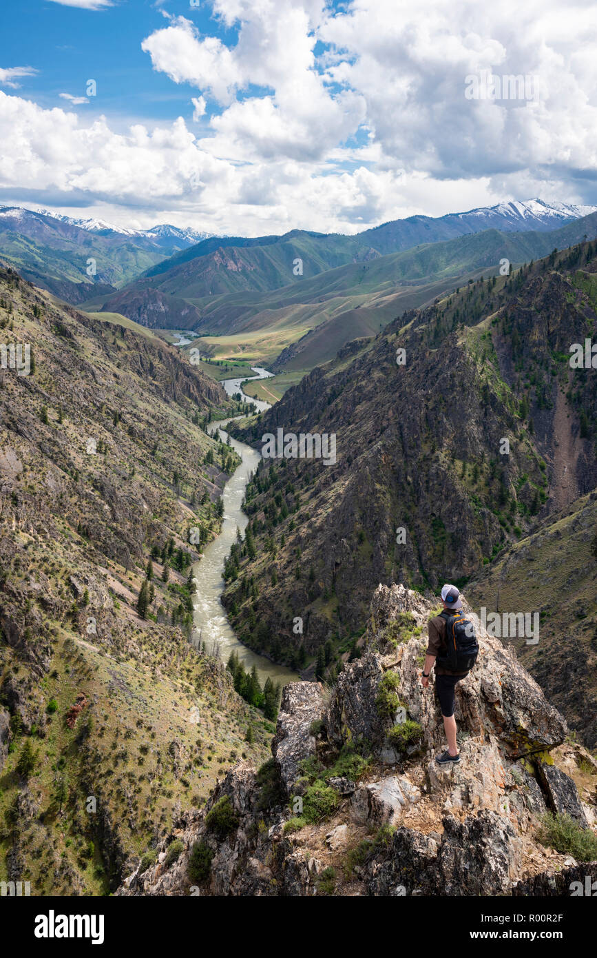 A hiker views the Middle Fork Salmon River in Idaho from Johnson Point above Little Pine Camp. With outfitter Far And Away Adventures. Stock Photo