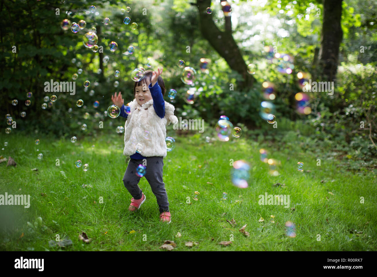 baby girl play bubble at Spring garden Stock Photo - Alamy
