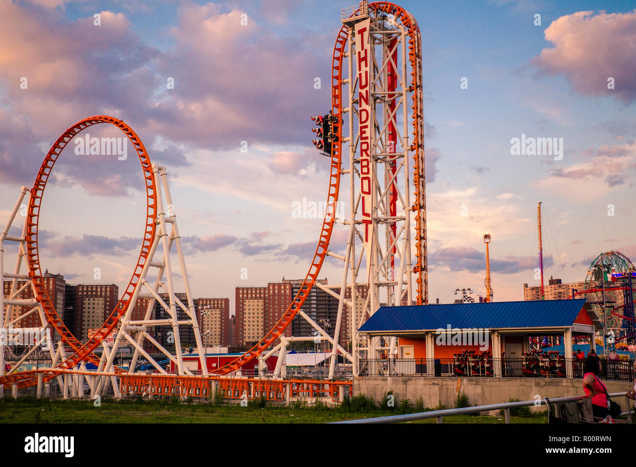 oney Island boardwalk in Brooklyn with amusement park rides Stock Photo