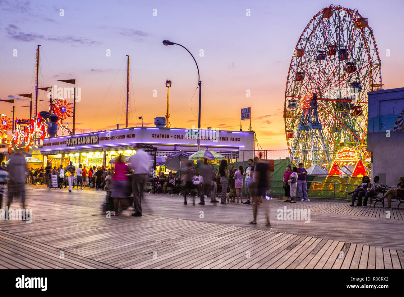 oney Island boardwalk in Brooklyn with amusement park rides Stock Photo