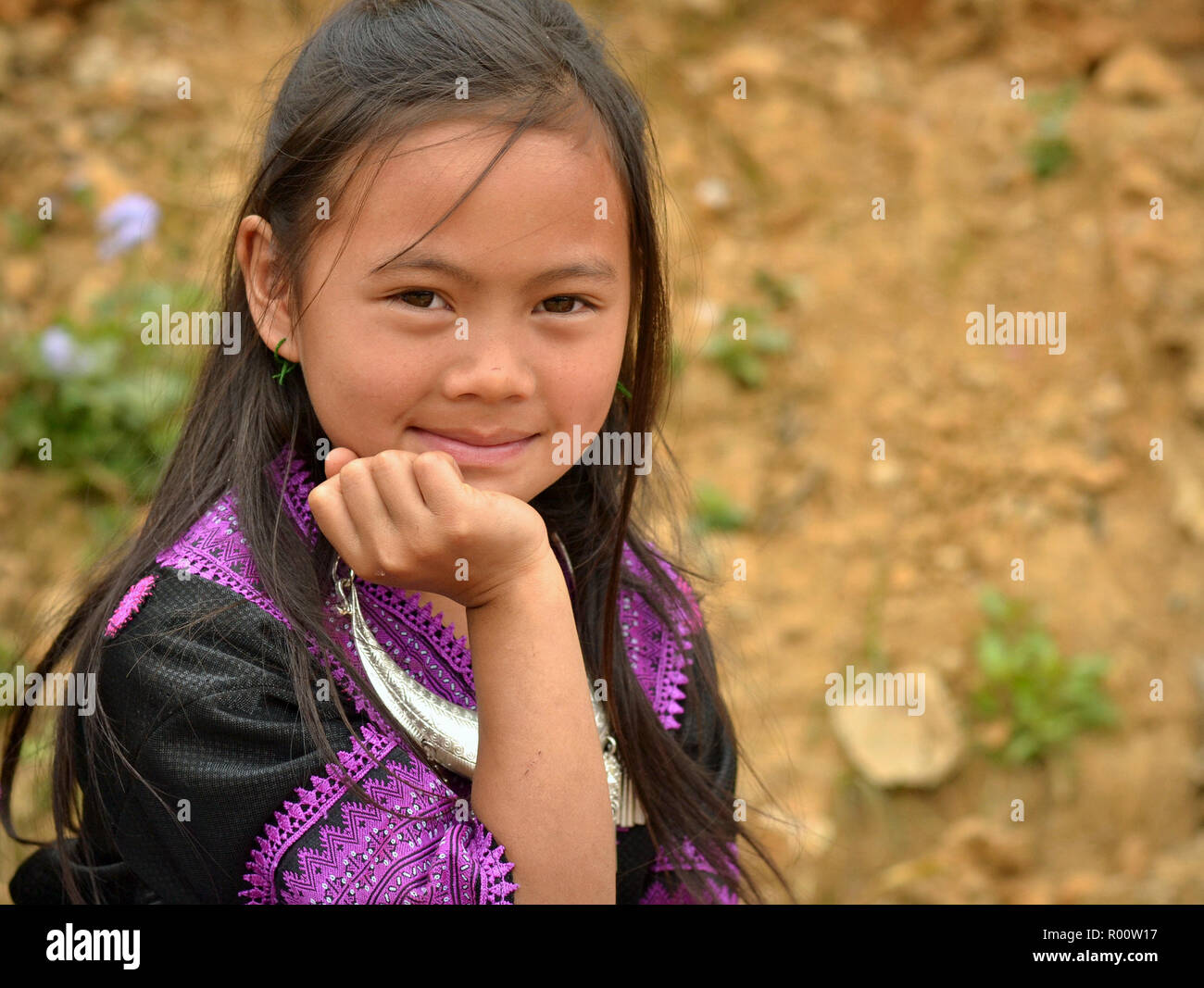 Young Vietnamese Black H’mong girl in traditional attire poses for the camera. Stock Photo