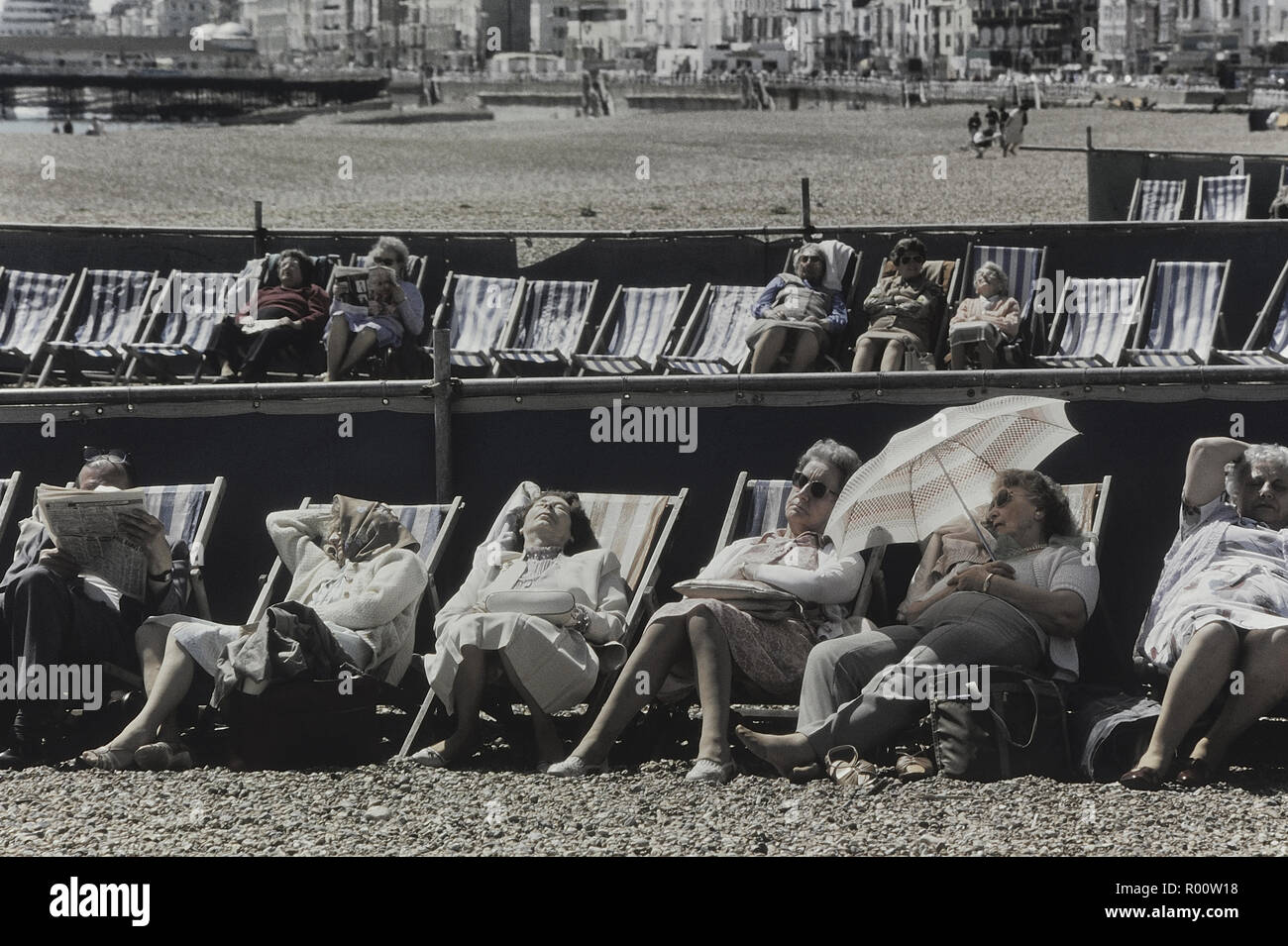 Senior citizens relaxing in deckchairs, Hastings, East Sussex, England, UK Stock Photo