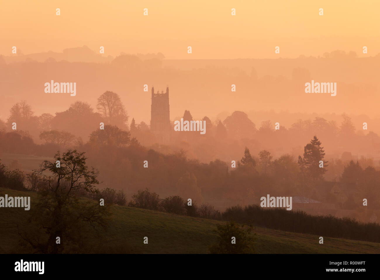 St James' church and misty cotswold landscape at sunrise, Chipping Campden, Cotswolds, Gloucestershire, England, United Kingdom, Europe Stock Photo