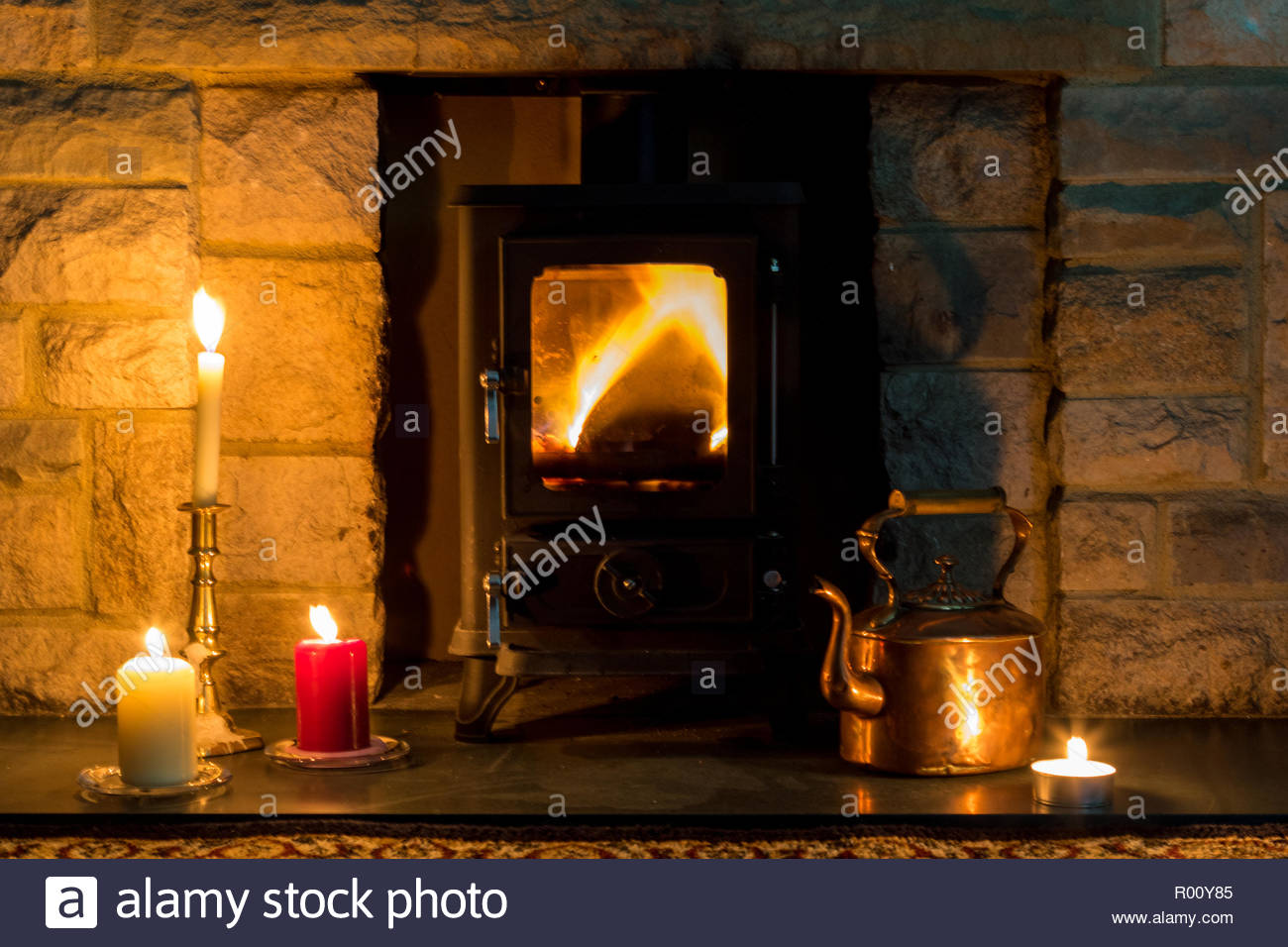 Hygge Concept A Log Burner Candles And A Copper Kettle In A