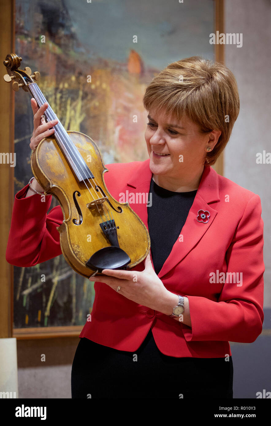 First Minister Nicola Sturgeon takes a closer look at the Wilfred Owen violin during a meeting with the organisers of the #iPlay4Peace crowdsourced world online concert which will take place on the afternoon of Armistice Day. Stock Photo