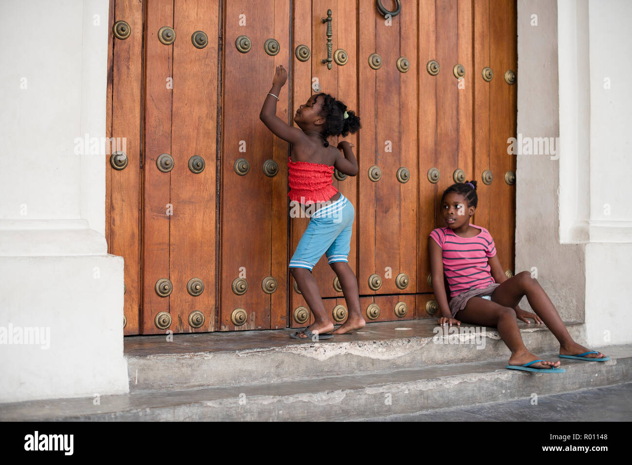 Some silly girls pose for the camera in a plaza in Havana, Cuba. Stock Photo