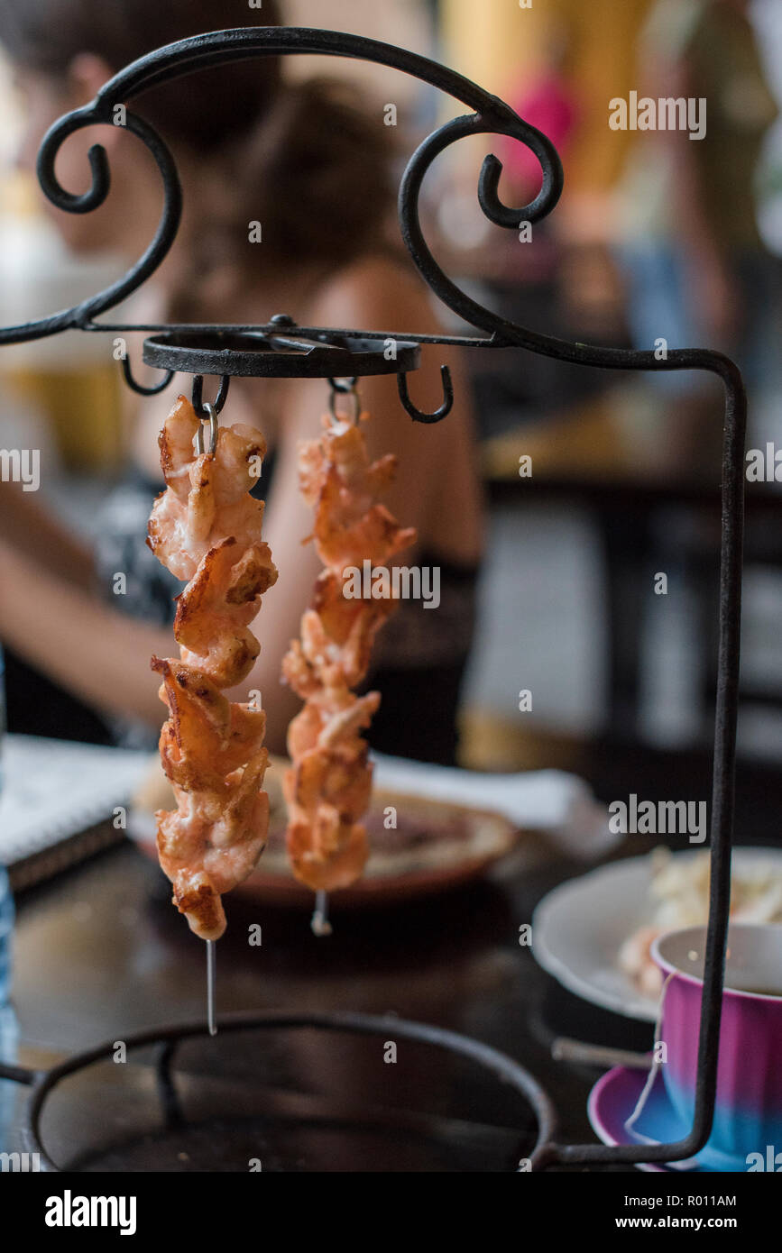 Meat kabobs waiting to be eaten at an open air restaurant in Havana, Cuba Stock Photo