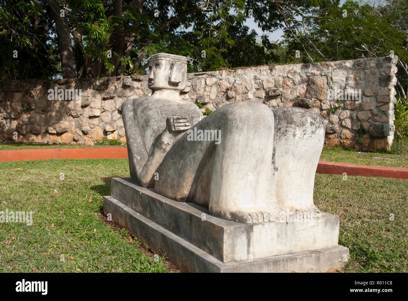 A modern Chacmool, a specific form of Mesoamerican sculpture of a reclining man, possibly symbolizing slain warriors, along the road to Chichen Itza. Stock Photo