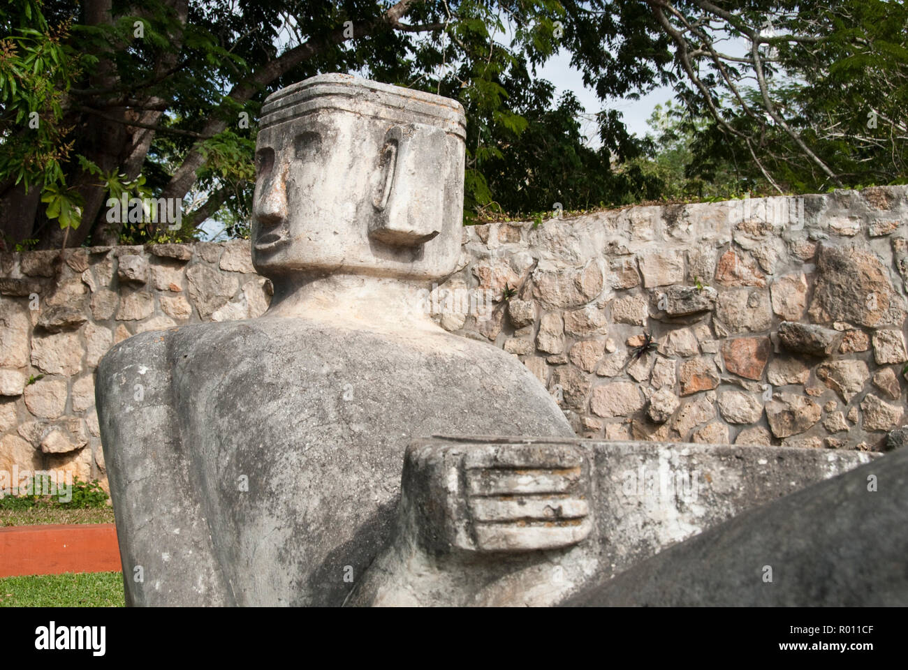 A modern Chacmool, a specific form of Mesoamerican sculpture of a reclining man, possibly symbolizing slain warriors, along the road to Chichen Itza. Stock Photo