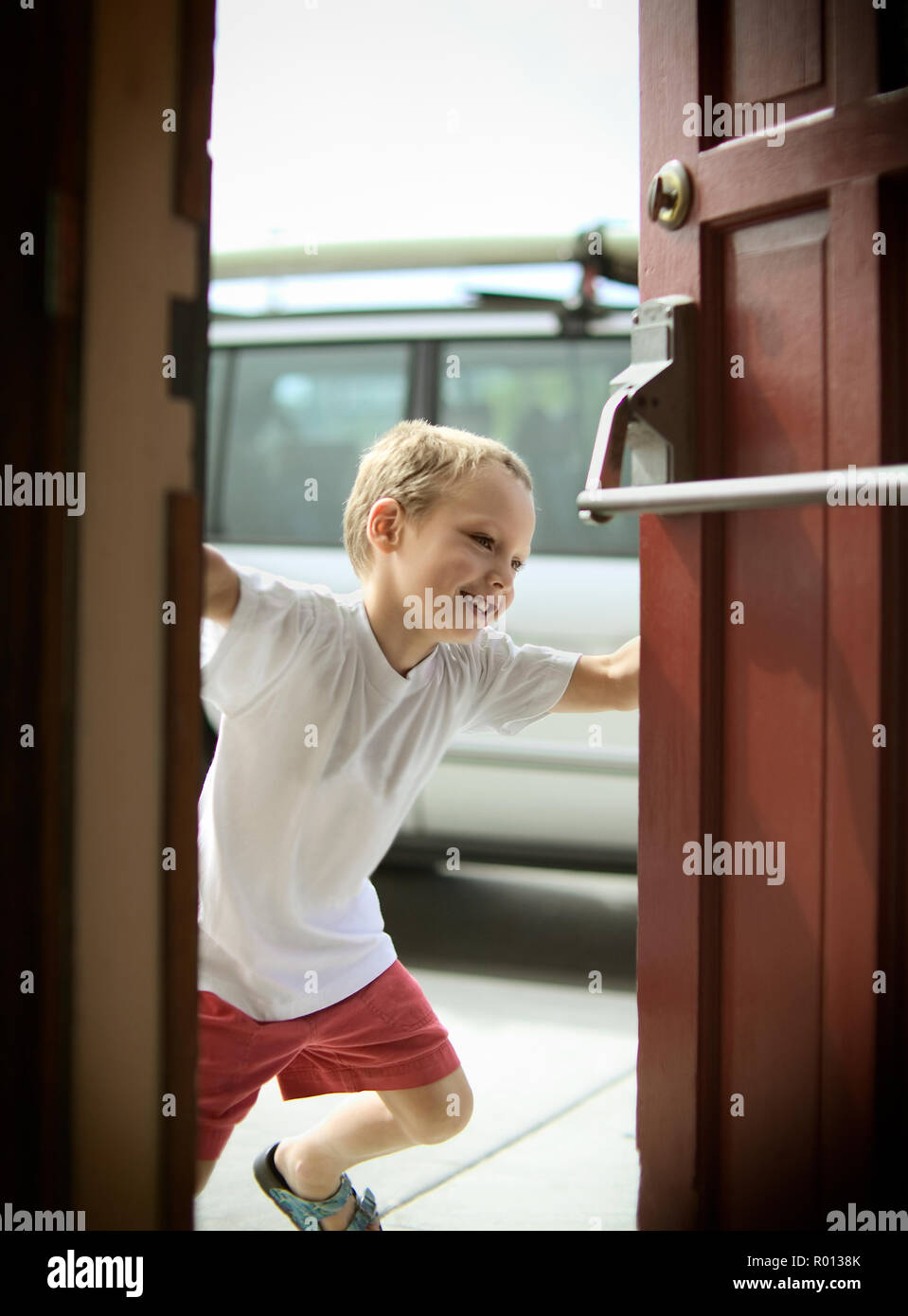 Boy closing door Stock Photo Alamy