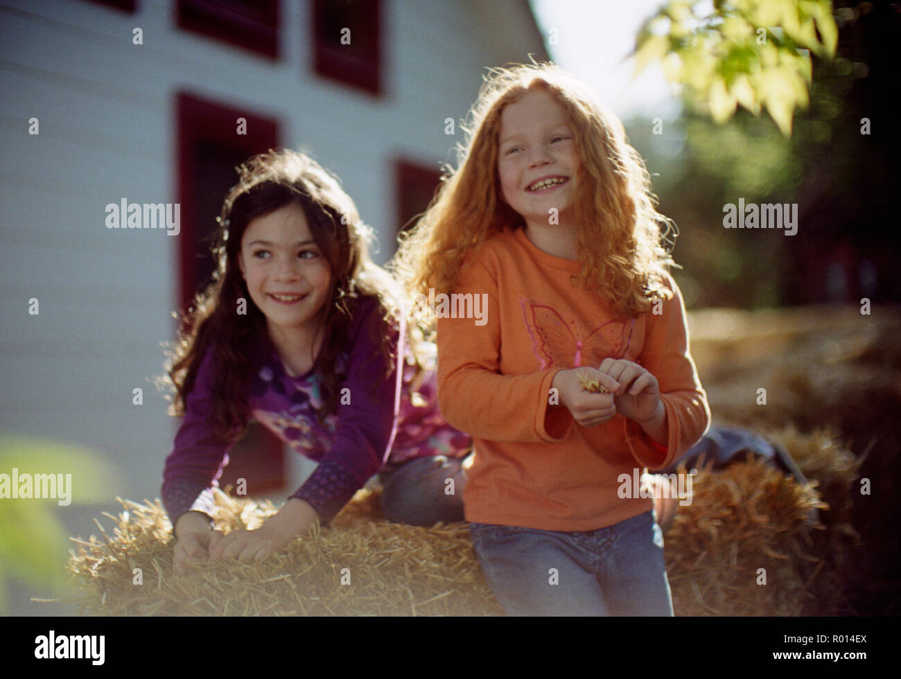 Two happy young girls playing together Stock Photo - Alamy