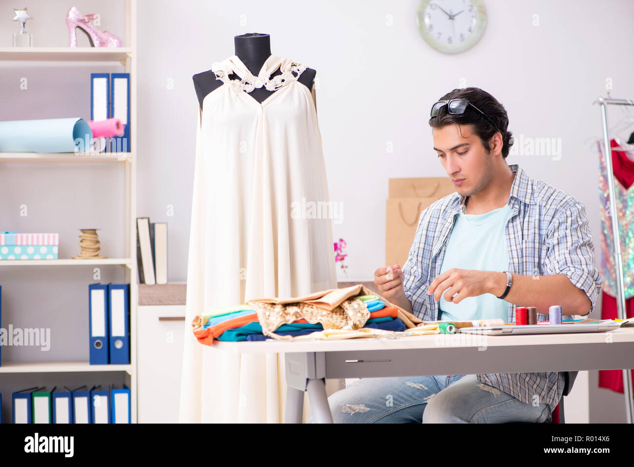 Young handsome tailor working in his workshop Stock Photo - Alamy
