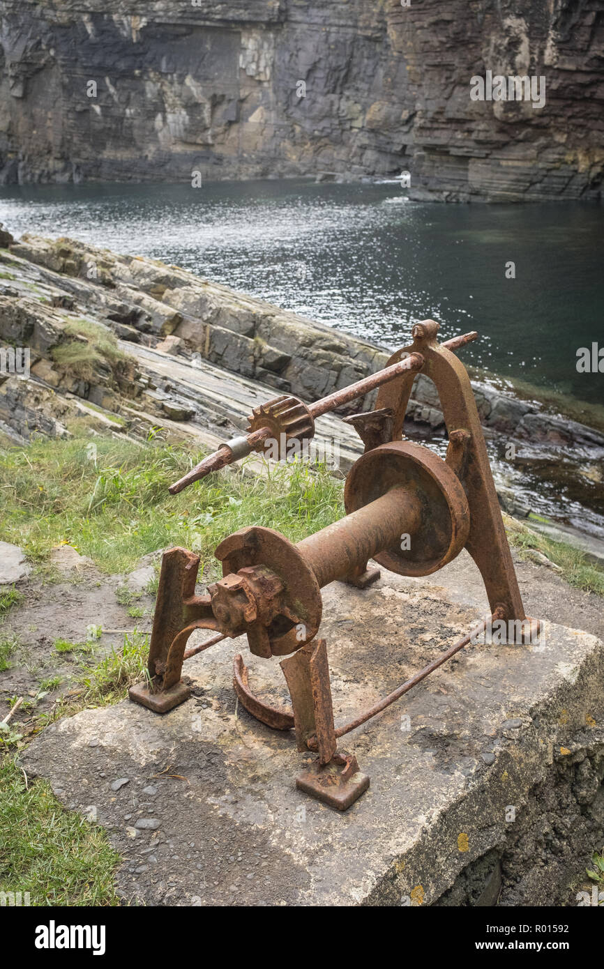 An old piece of machinery, probably a winch, at the foot of the Whaligoe Steps in Caithness, Scotland. Stock Photo