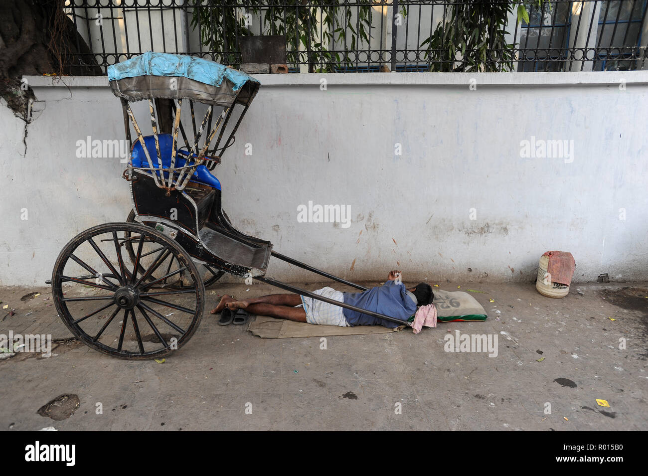 Kolkata, India, Asia, A rikshawker sleeping at the roadside Stock Photo