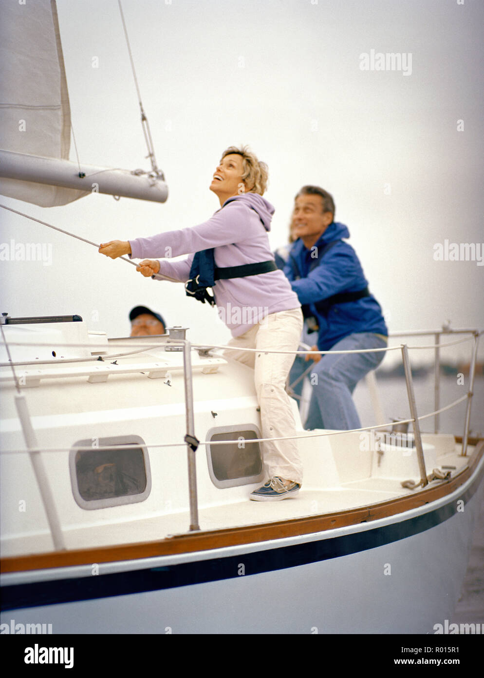 Tuggig Rope A woman is tugging at a rope with the help of a man Stock Photo - Alamy