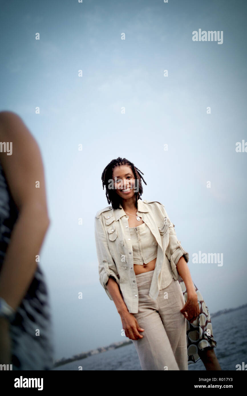 Portrait of a smiling young woman at the beach Stock Photo - Alamy