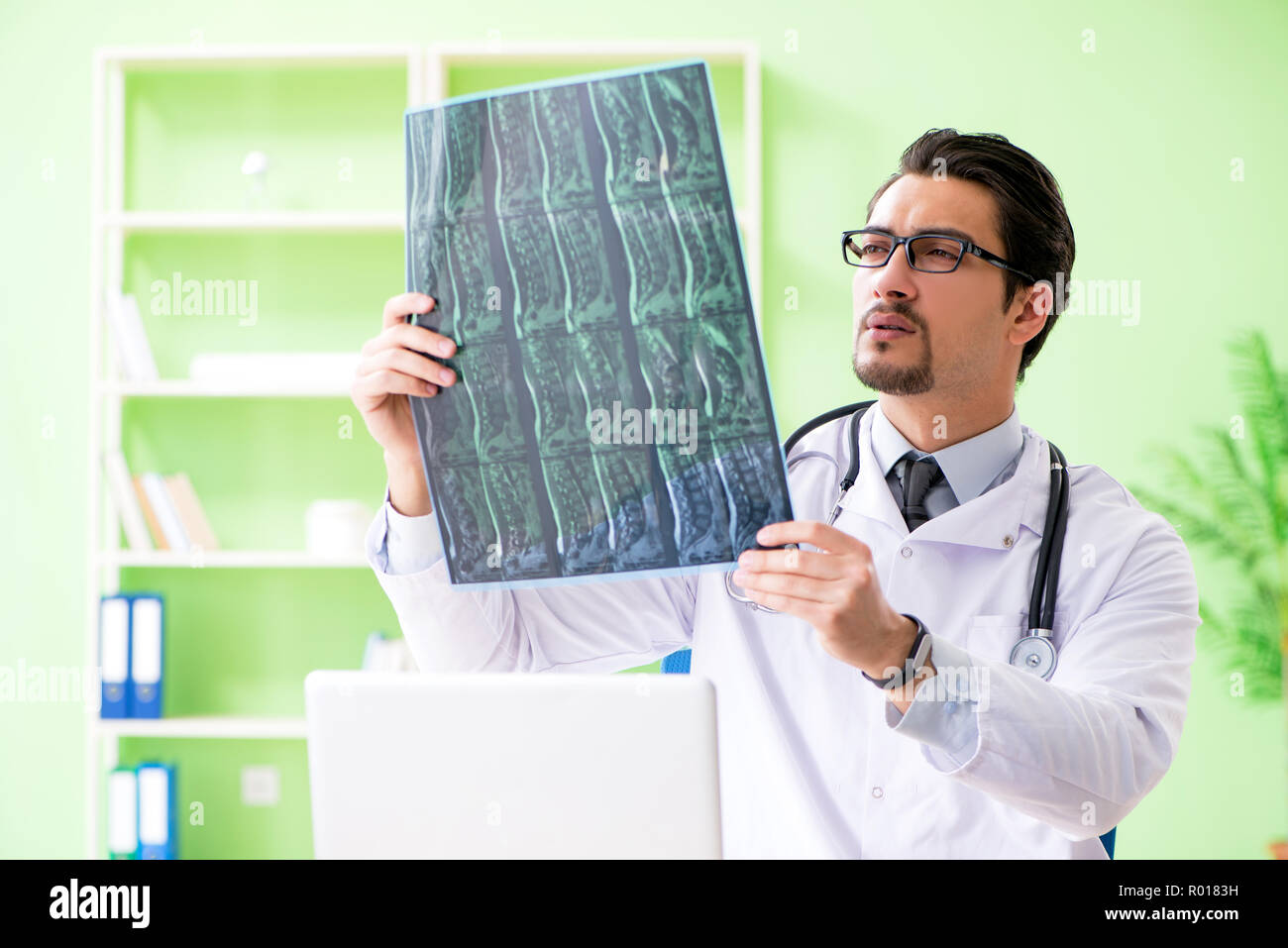 Doctor radiologist looking at x-ray scan in hospital Stock Photo - Alamy