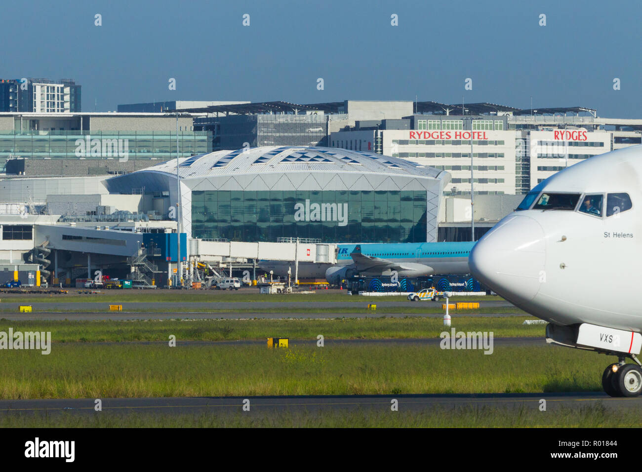 Detail from Sydney (Kingsford Smith) Airport in Sydney, Australia, looking towards the International Terminal on the western side of the airport. Pictured: a Qantas B737 (call sign VH-VXS) taxying. Stock Photo