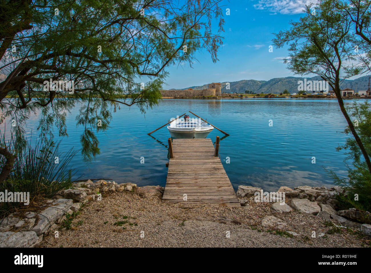 ALBANIA, BUTRINT. Small boat waiting for passangers to be transfered across the canal to the venetian fort Stock Photo