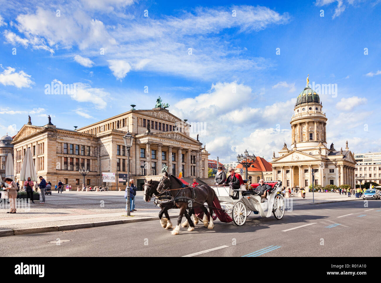 22 September 2018: Berlin, Germany - Horse-drawn carriage ride in Gendarmenmarkt Square, with the Konzerthaus on the left and the French Church on the Stock Photo