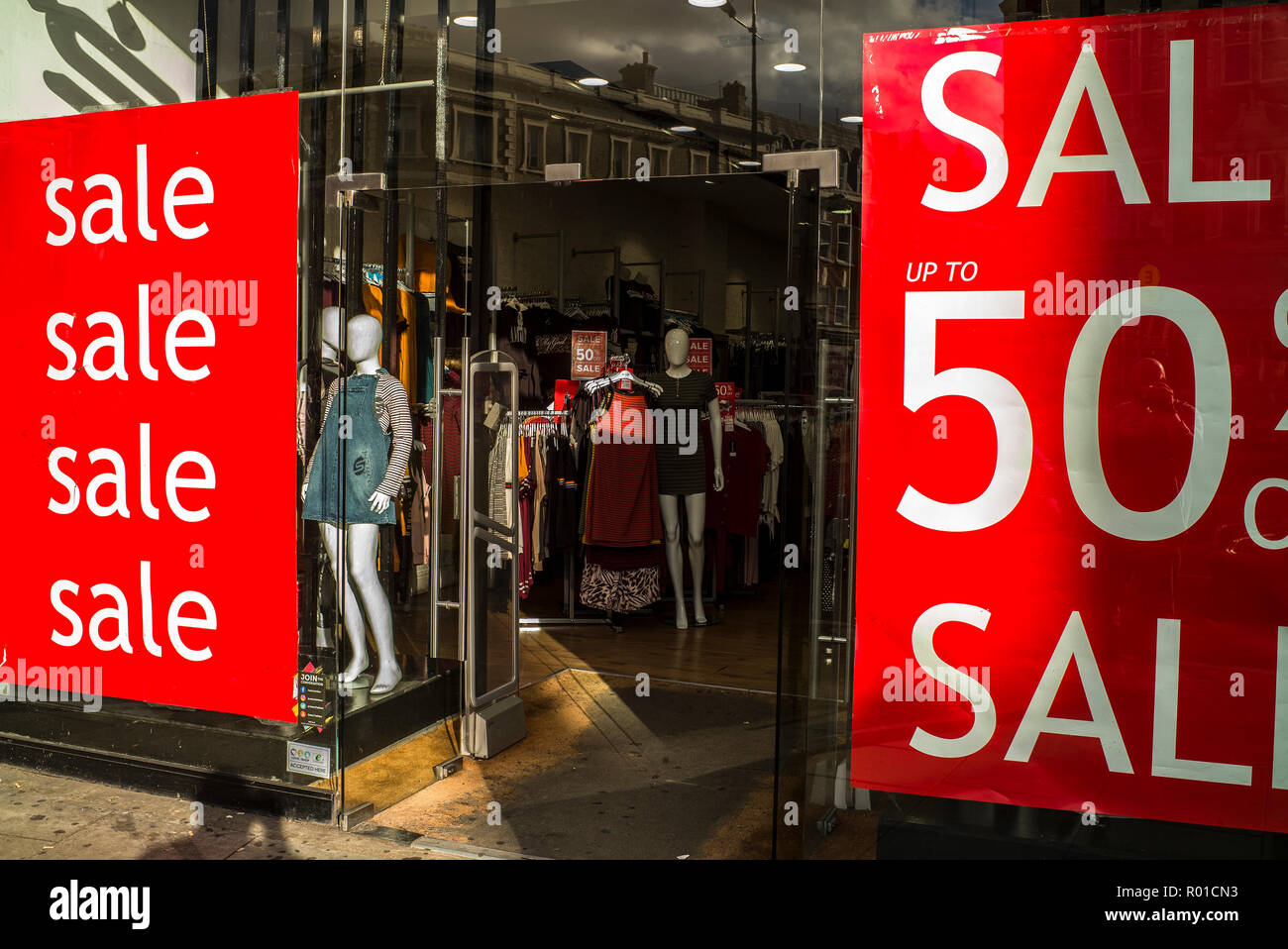 50% sale signs in fashion outlet shop window Stock Photo - Alamy