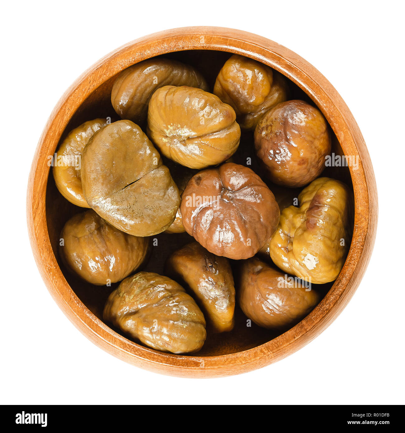 Cooked sweet chestnuts in wooden bowl. Edible seeds or nuts of Castanea sativa, also called marron and Spanish or Portuguese chestnut. Stock Photo