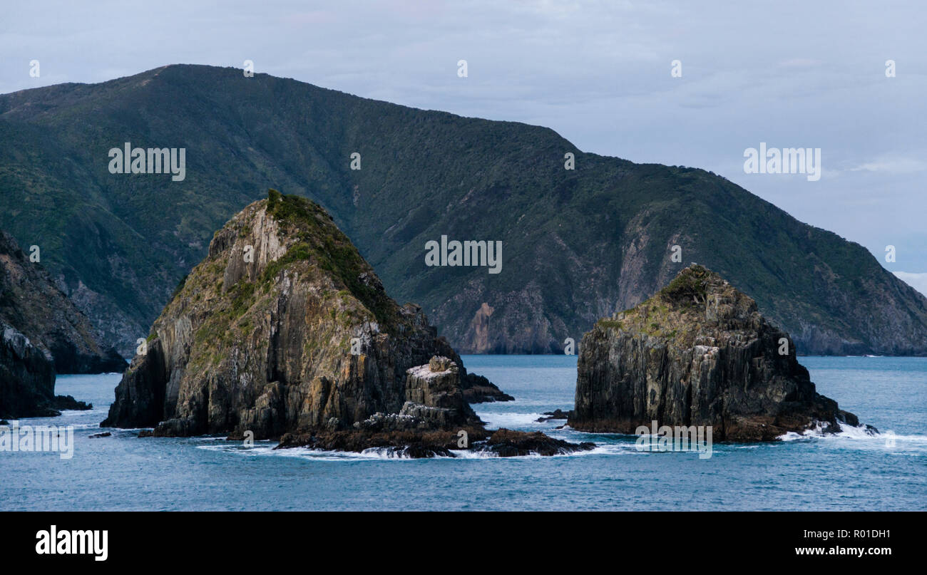 The rocky outcroppings of Arapawa Island, where the waters of the Marlborough Sounds meet the Cook Strait in New Zealand Stock Photo