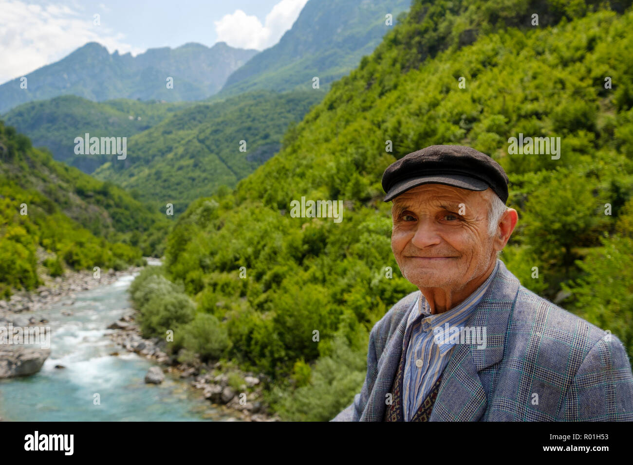 Old man in front of river Cem i Vuklit, Tamara, Tamarë, region Kelmend, Albanian Alps, Prokletije, Qark Shkodra, Albania Stock Photo