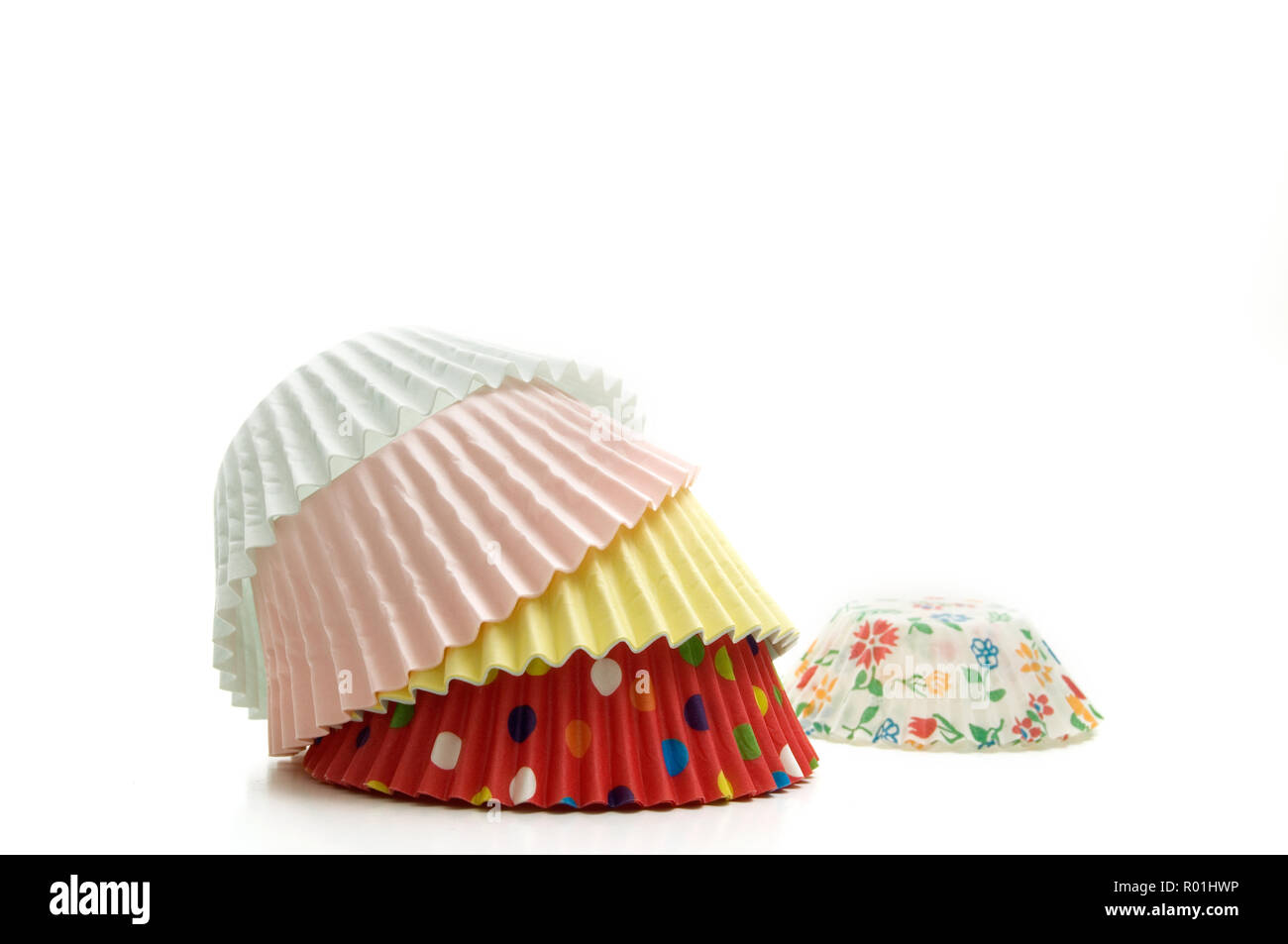 Stacked Multi-Colored Muffin Baking Cups on White Background Horizontal Image Stock Photo