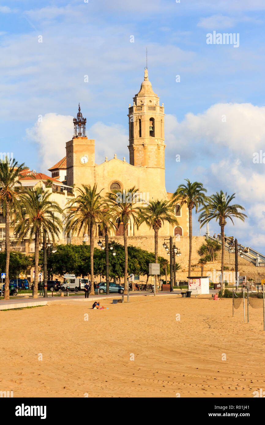 Beach and church with palm trees, Sitges, Spain Stock Photo