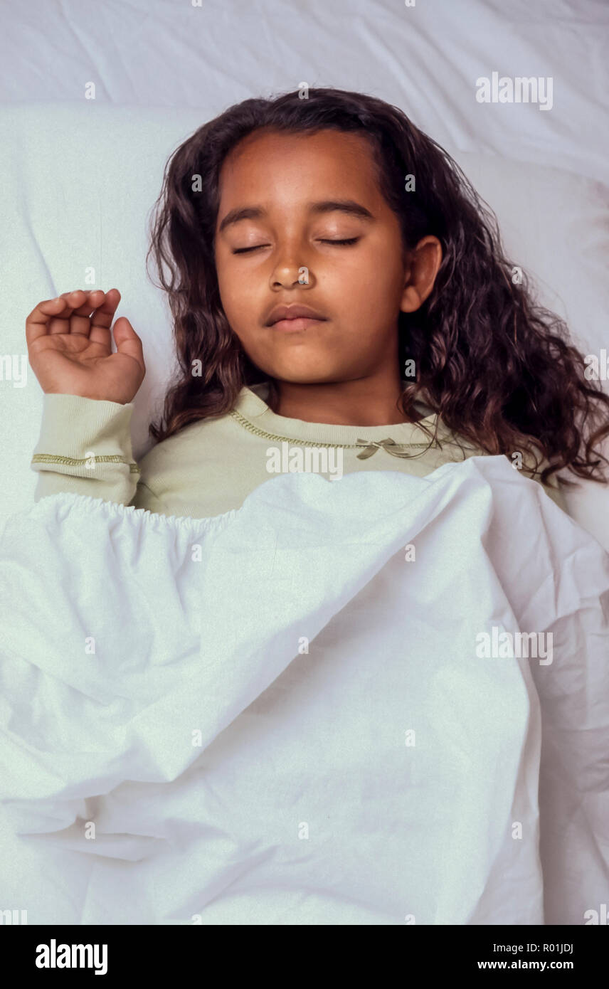 Bedtime for young Girl  7-10 year old asleep in bed African American/Caucasian. MR.  © Myrleen Pearson ........Ferguson Cate Stock Photo