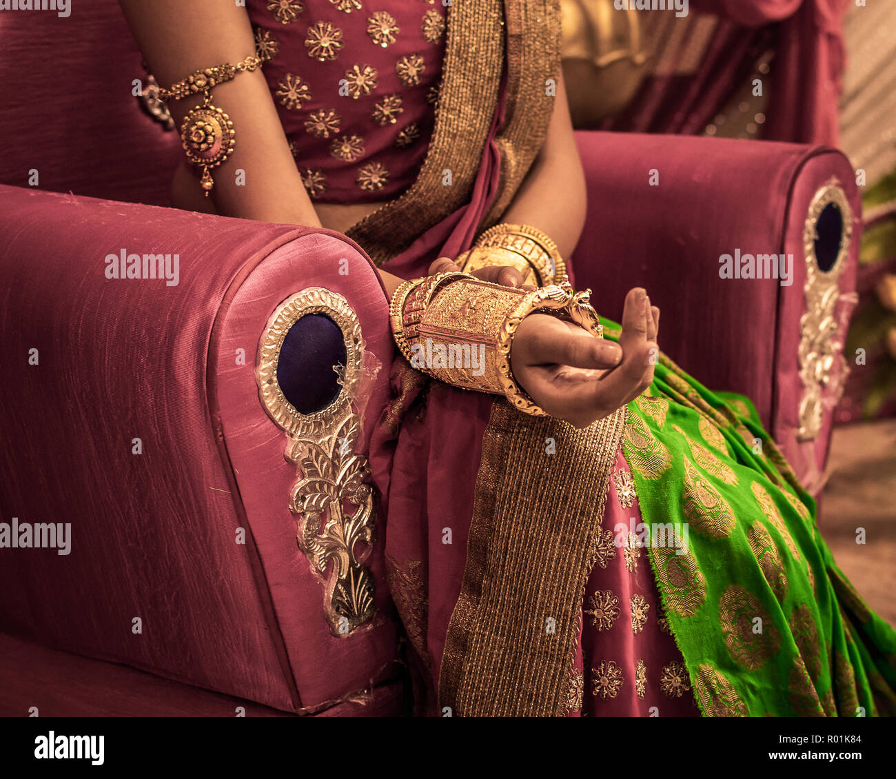 Close up  of Decorative Golden Bangles of Indian Bride with Selective Focus. Stock Photo