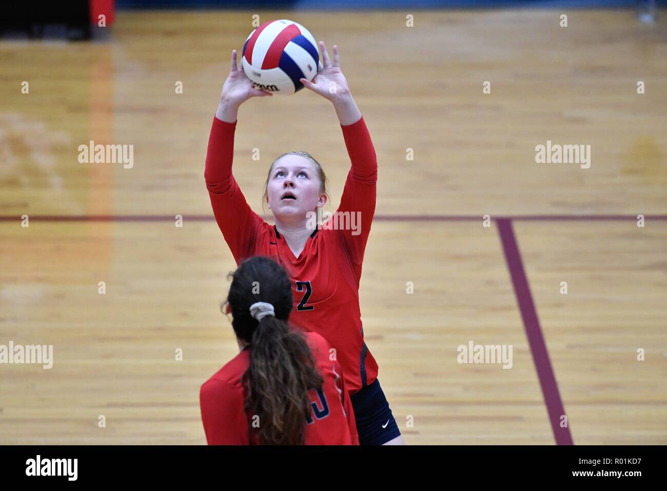 Player setting for a teammate during a high school match. USA. Stock Photo
