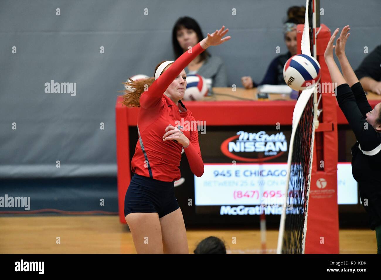 Player delivering a match-winning point via a kill shot that touched the net on its way. USA. Stock Photo