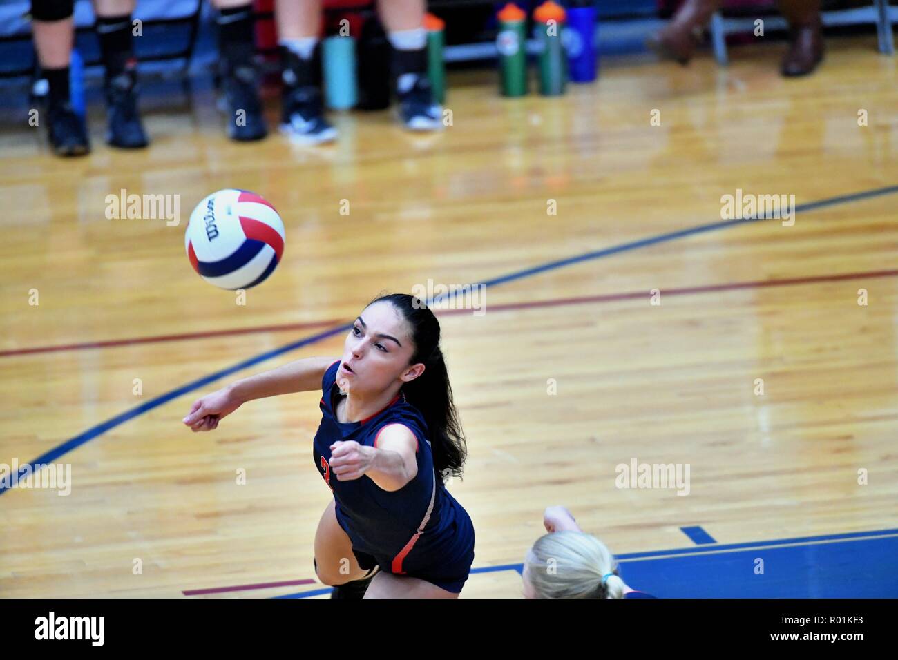 Player extending in reaction to an opponent's kill shot in an effort to sustain a volley. USA. Stock Photo