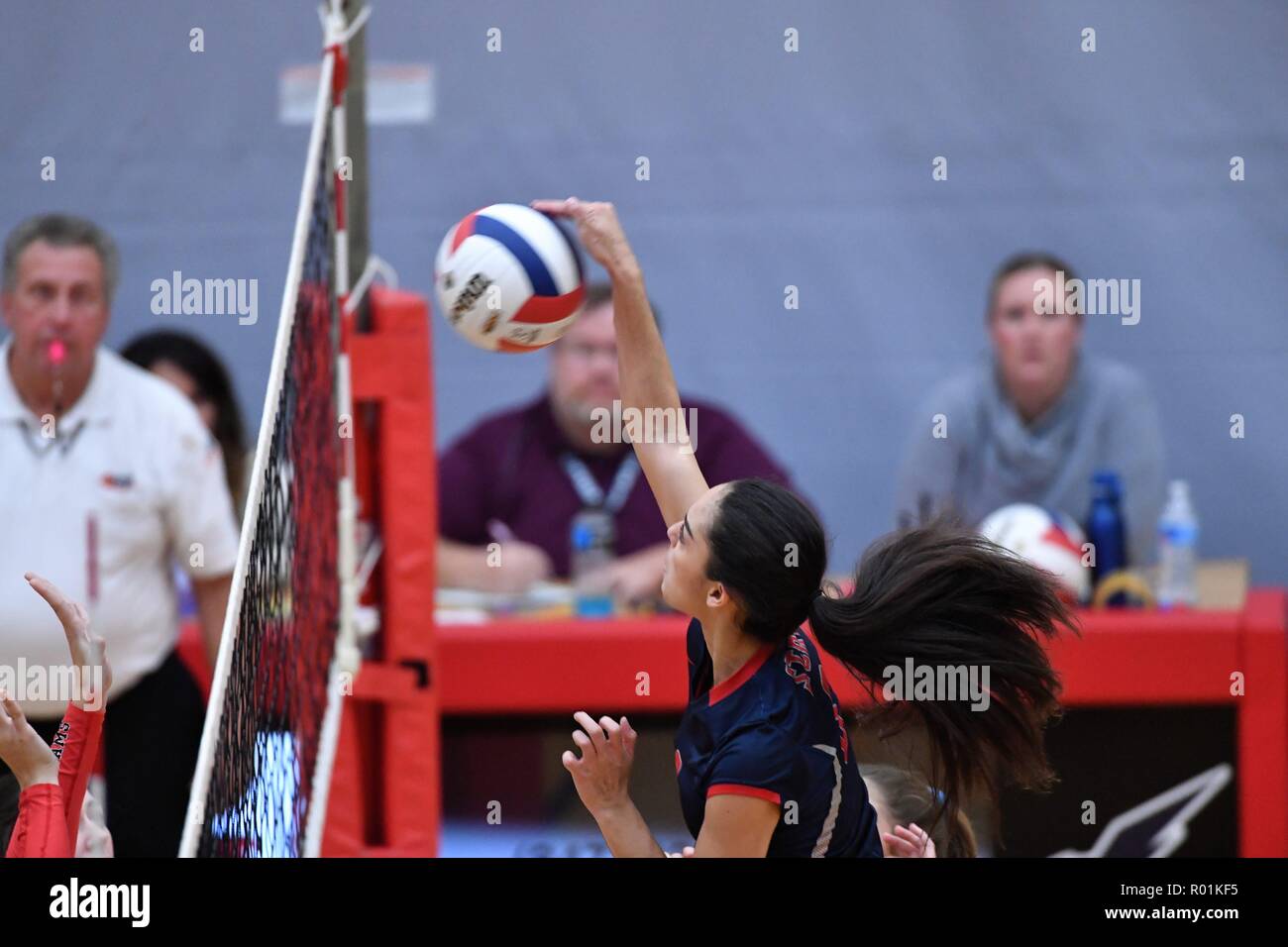 Player finessing a lop kill shot over the net. USA Stock Photo