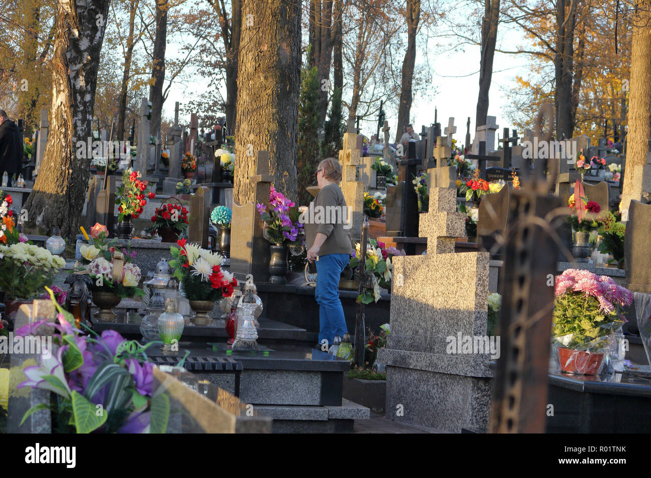ZACHELMIE, POLAND - OCTOBER 31, 2018: A woman tends to a grave in cemetery on the eve of All Saints' Day. Credit: Slawomir Wojcik/Alamy Live News Stock Photo