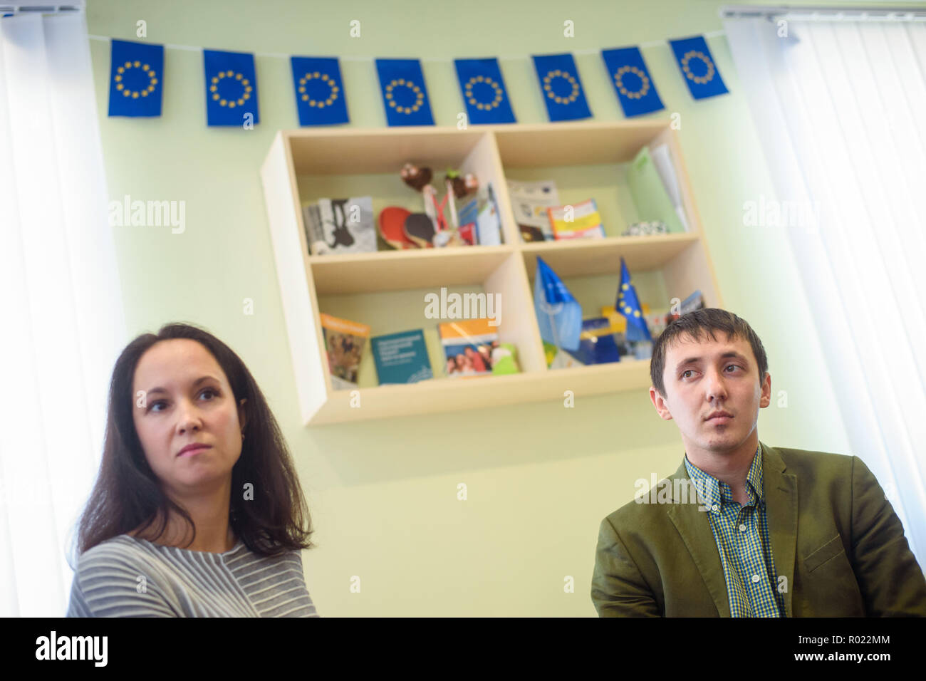 Chuguiiv, Ukraine. 30th Oct, 2018. Svitlana Manuylova (l-r), internally displaced person and children's book author, and Ivan Chubukin, director of the city's youth centre, sit in the centre for children and young people with journalists for a conversation. After clashes between the Ukrainian military and pro-Russian separatists in Eastern Ukraine, many houses and infrastructure were severely damaged and partly renovated and rebuilt by German development aid. Credit: Gregor Fischer/dpa/Alamy Live News Stock Photo