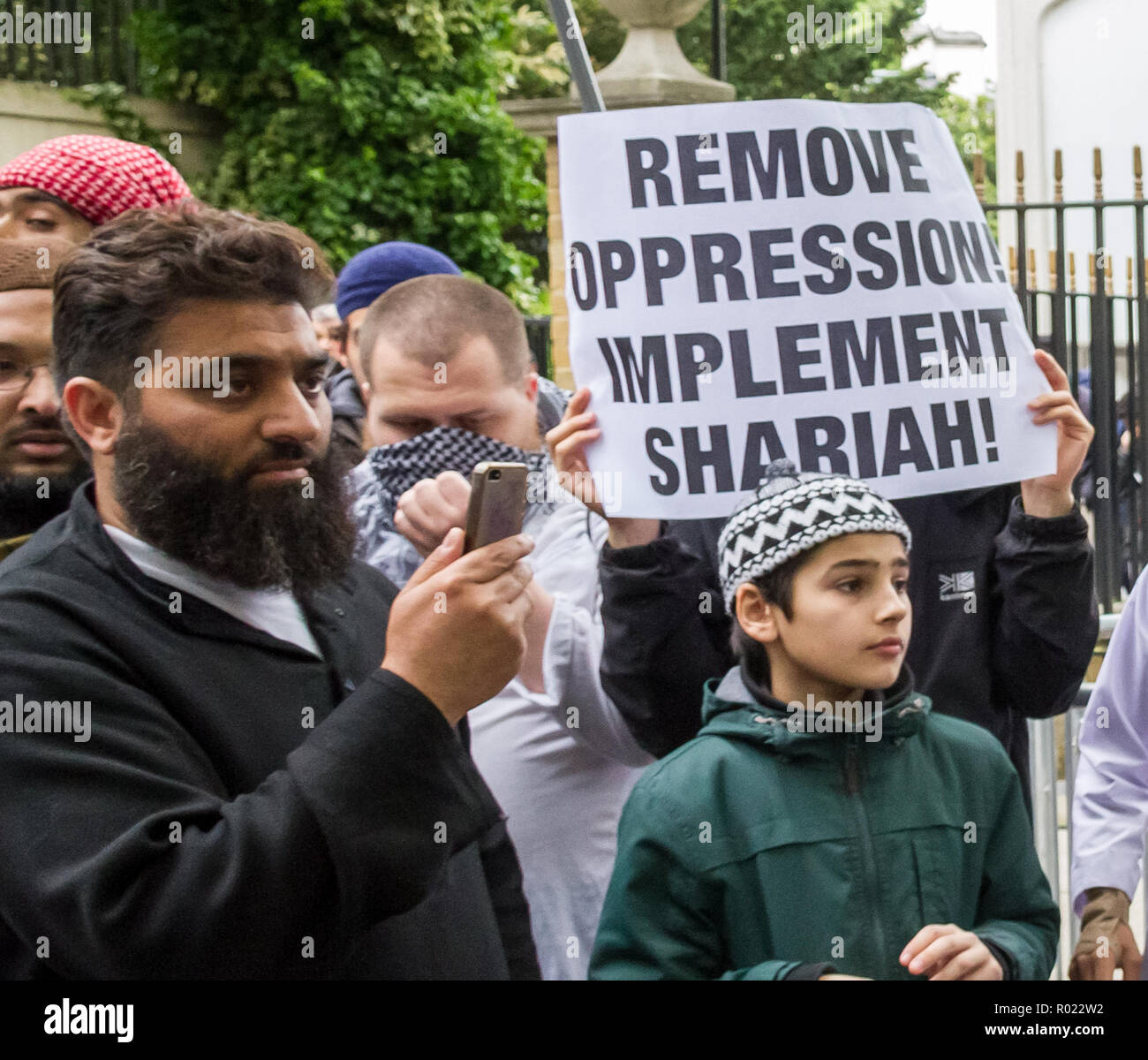 London, UK. 30th May, 2014. File Image from 30-05-2014: Lewis Ludlow, 26, from Rochester in Kent, a Muslim convert (pic centre, face covering) also used the name Ali Hussain, is due to be sentenced for plotting an Islamic State-inspired attack on Oxford Street in which he hoped to kill 100 people. Ludlow is seen here in 2014 outside the London Central Mosque during a protest organised by radical cleric Anjem Choudary and his banned Al-Muhajiroun (ALM) group. Credit: Guy Corbishley/Alamy Live News Stock Photo