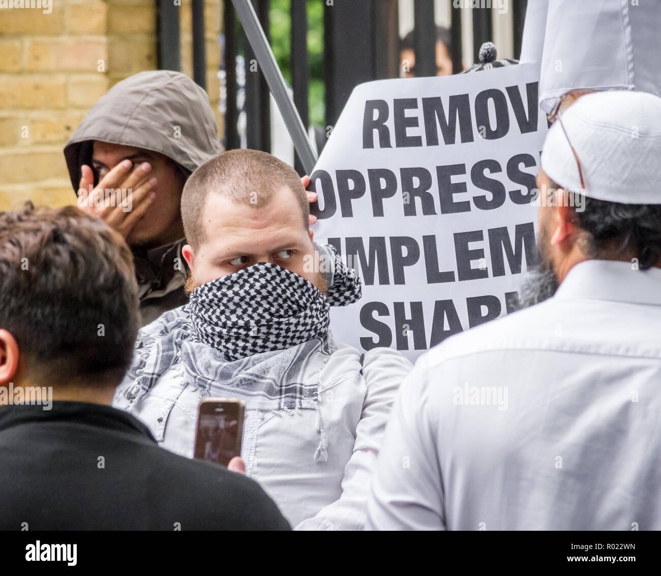 London, UK. 30th May, 2014. File Image from 30-05-2014: Lewis Ludlow, 26, from Rochester in Kent, a Muslim convert (pic centre, face covering) also used the name Ali Hussain, is due to be sentenced for plotting an Islamic State-inspired attack on Oxford Street in which he hoped to kill 100 people. Ludlow is seen here in 2014 outside the London Central Mosque during a protest organised by radical cleric Anjem Choudary and his banned Al-Muhajiroun (ALM) group. Credit: Guy Corbishley/Alamy Live News Stock Photo