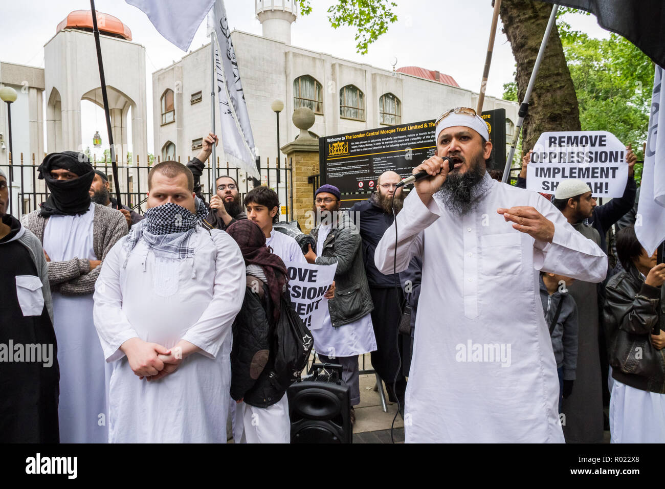 London, UK. 30th May, 2014. File Image from 30-05-2014: Lewis Ludlow, 26, from Rochester in Kent, a Muslim convert (second left, face covering) also used the name Ali Hussain, is due to be sentenced for plotting an Islamic State-inspired attack on Oxford Street in which he hoped to kill 100 people. Ludlow is seen here in 2014 outside the London Central Mosque during a protest organised by banned Al-Muhajiroun (ALM) members. Credit: Guy Corbishley/Alamy Live News Stock Photo