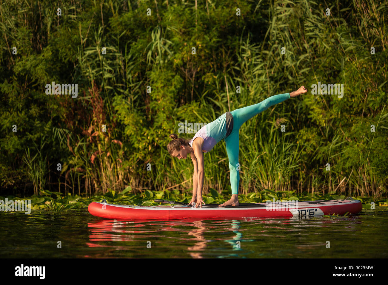 Photo of young woman doing hand stand 