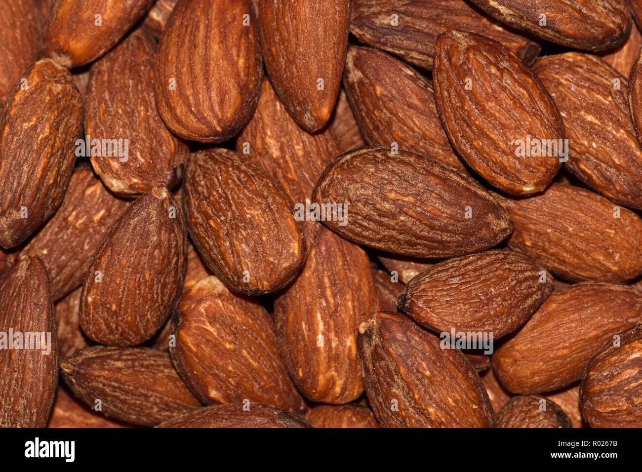 Unshelled, unsalted almonds from an overhead view and loosely scattered