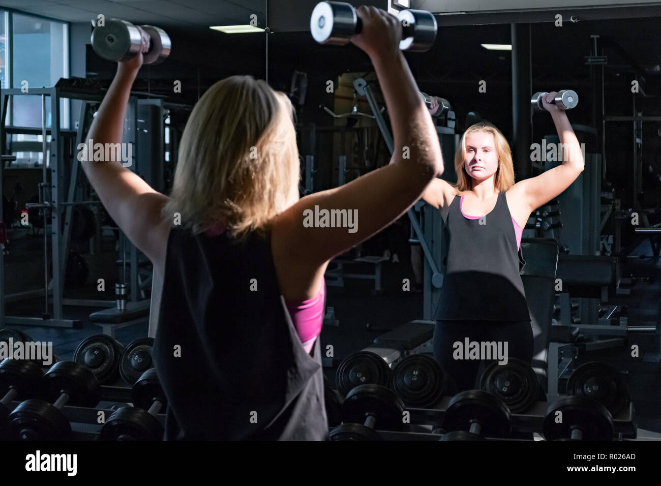 Young Fit Woman At The Gym Doing Heavylifting Exercise With Bar Bells
