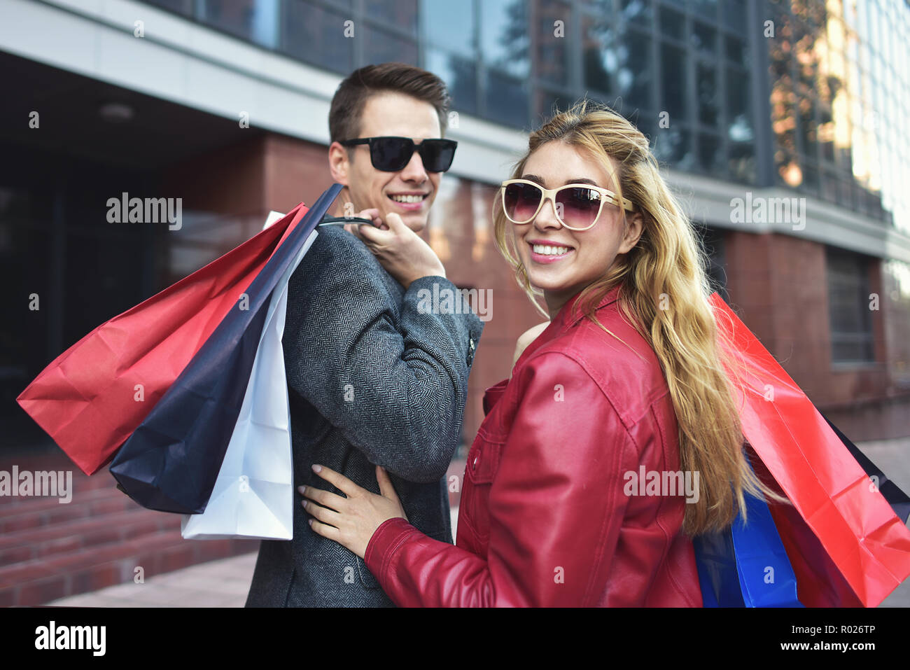 Portrait of a couple with shopping bags in the city.People, sale, love and happiness concept. Stock Photo