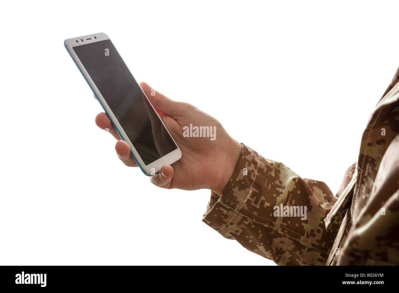 US Army. Young soldier holding a mobile phone standing on white background Stock Photo